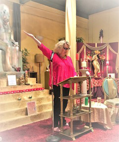 Starr Goode giving a lecture on the origins of art and pink pussy hats